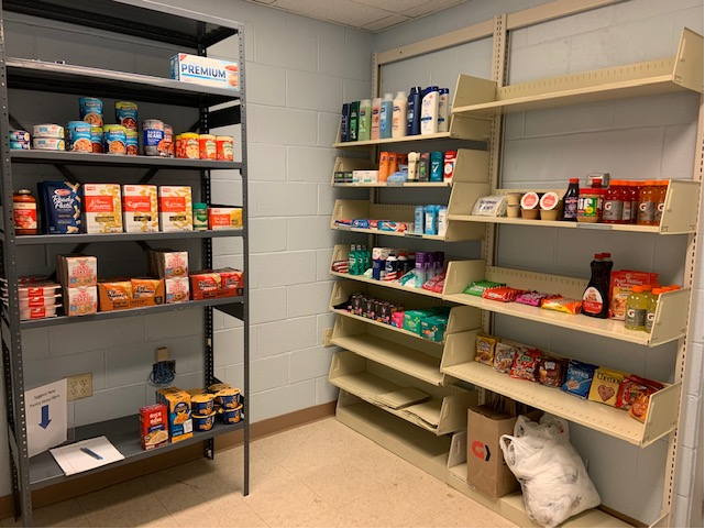 Several shelves stocked with dry food items and personal hygiene items.